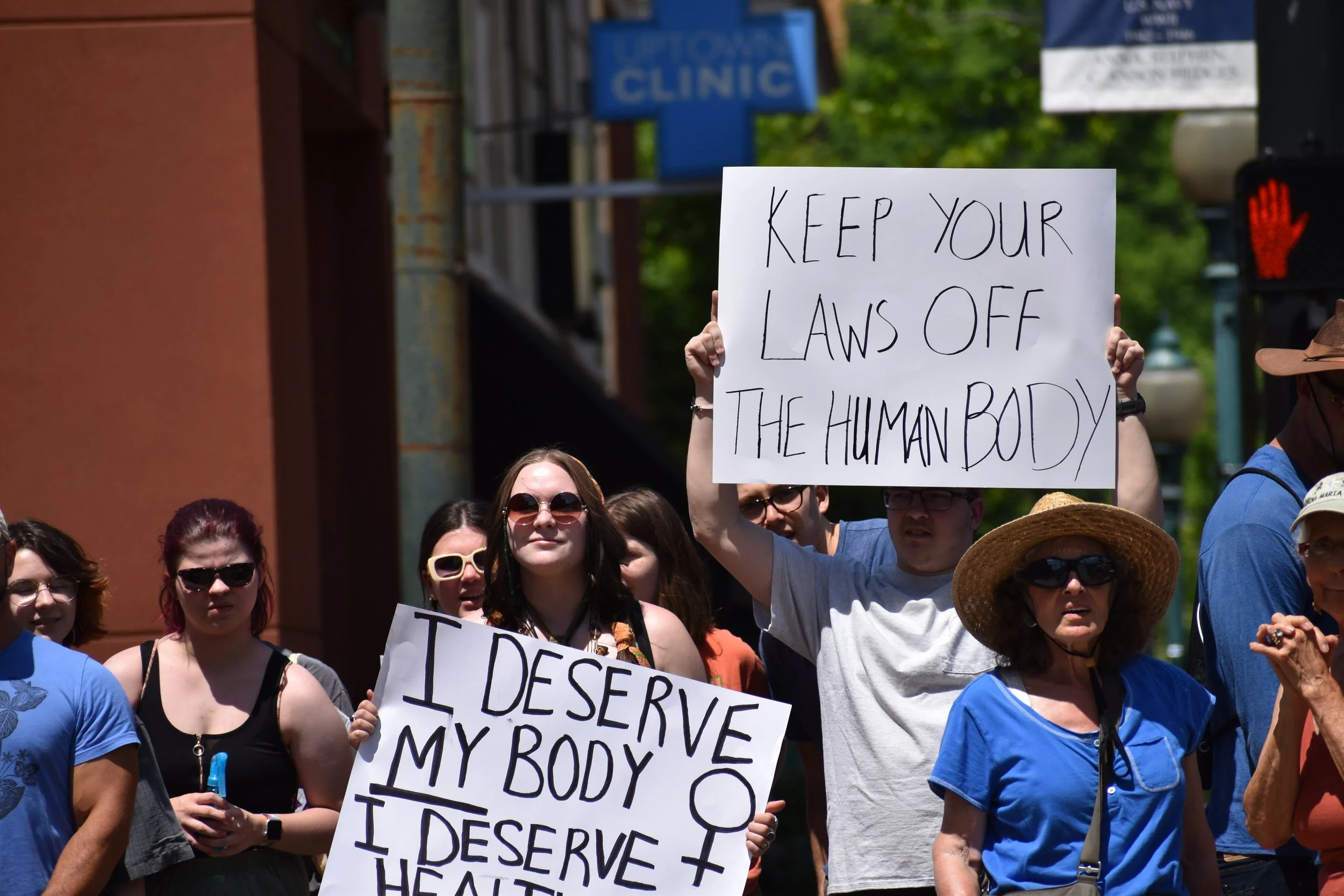  Protestors hold signs in support of women's rights. Photo by Bo Kuhn. 