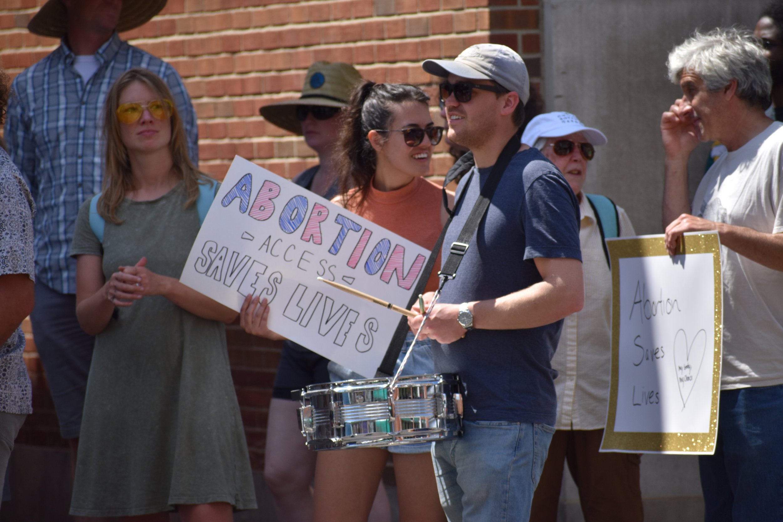  A protestor drums along as the group marches down Court Street. Photo by Bo Kuhn. 