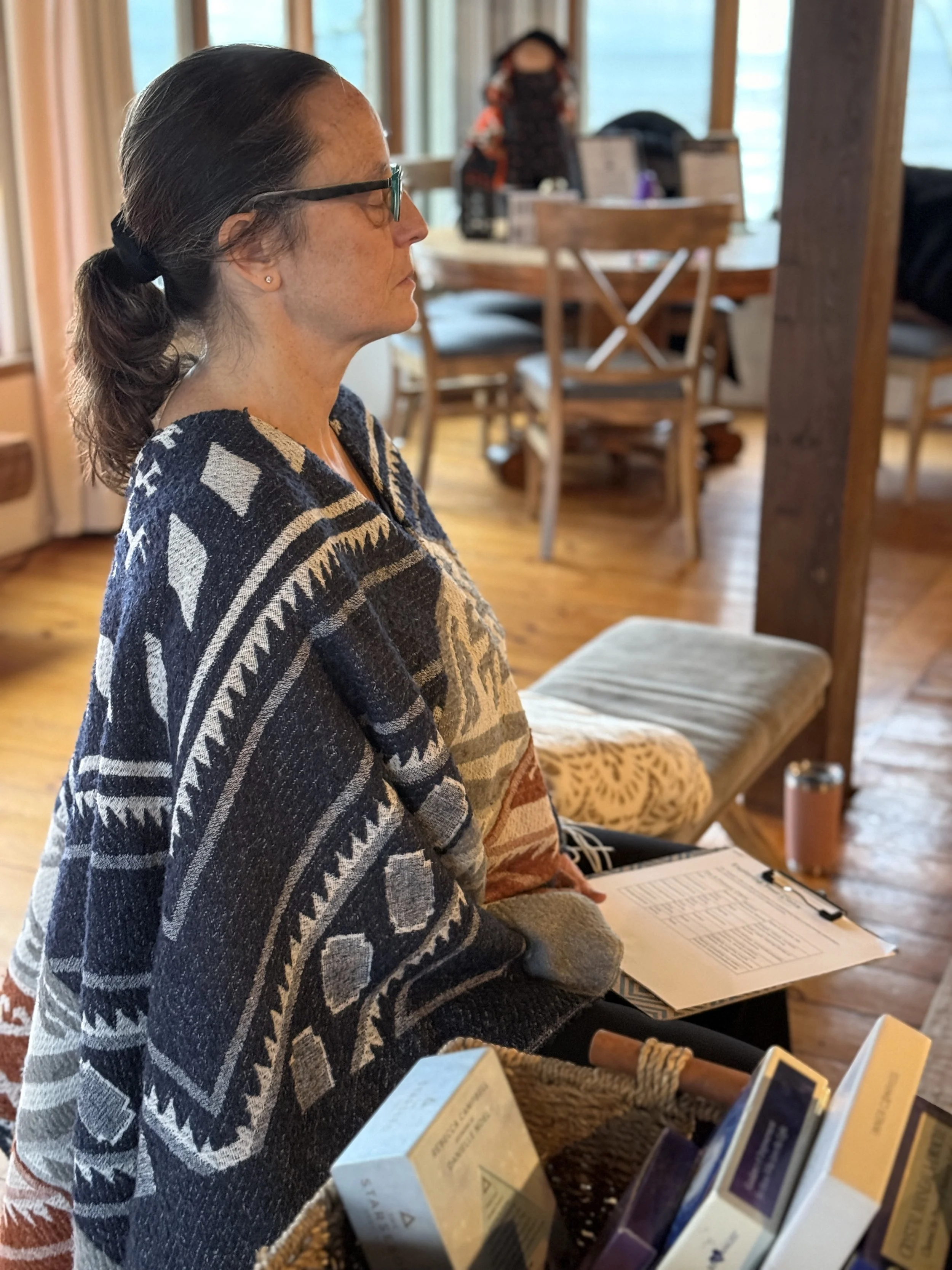 A women sits in meditation looking peaceful and calm.