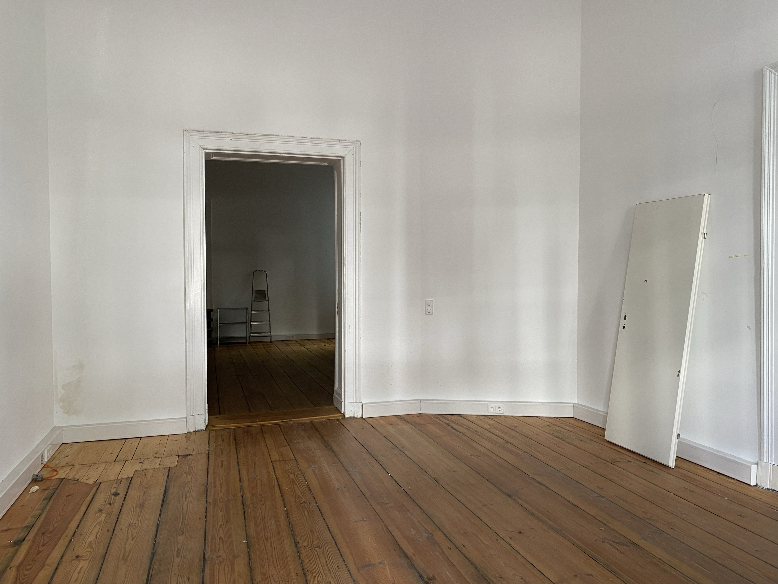First room facing the street, with a view into the second room