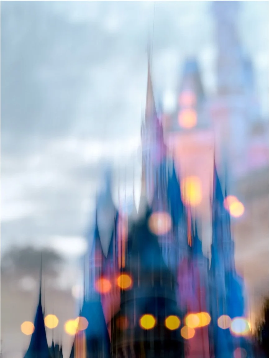 abstract double exposure image of Walt Disney world magic kingdom Cinderellas castle. large yellow bokeh lights placed on top of several images of the castle. 