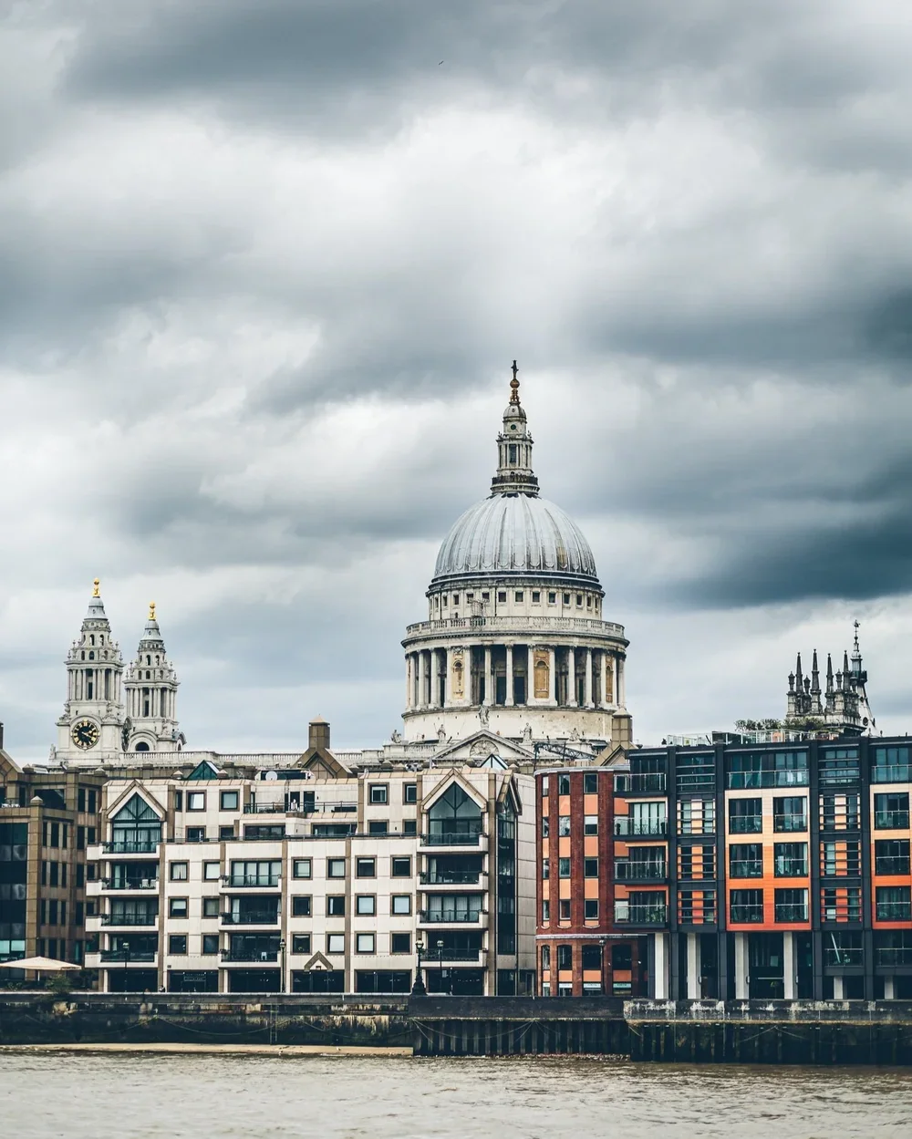 st pauls photographed from across the river with a dark cloudy sky.