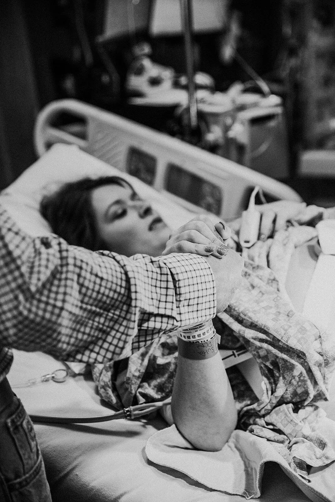 close up of a laboring woman's hand holding her husband's hand | Midland Memorial Hospital birth photography
