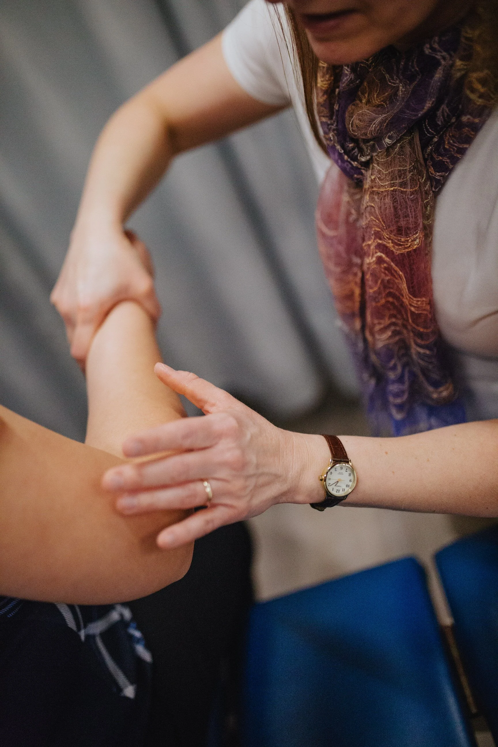 Physiotherapist checks mobility in patient's arm after a motor vehicle accident.