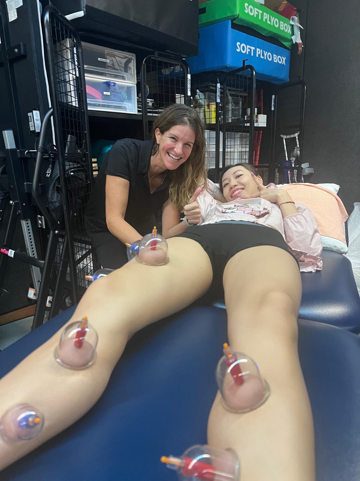 Shari Black (left) treats Vanessa Lai (right) using cupping therapy in Hong Kong