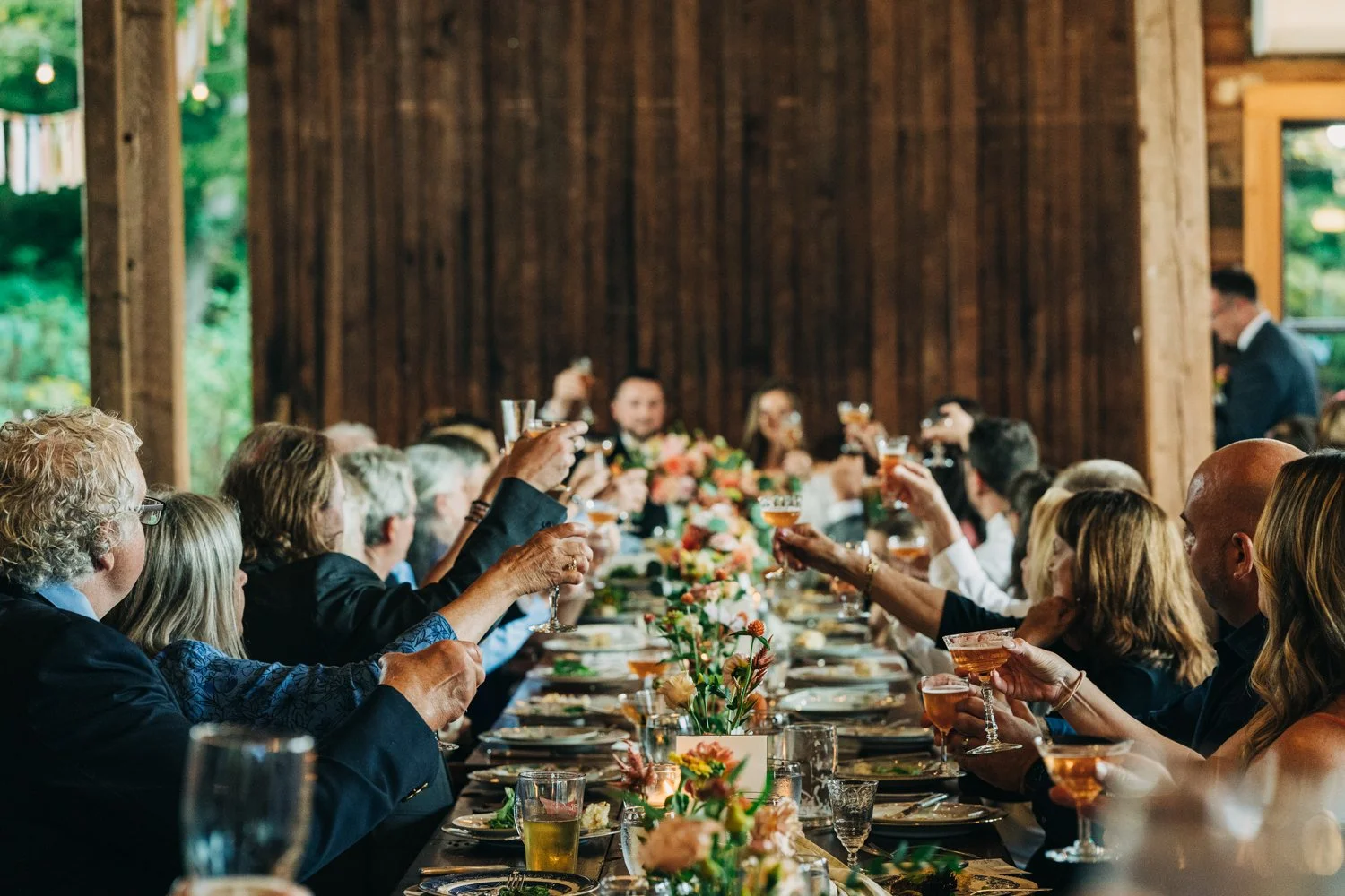 Guests raise a toast to a bride and groom during their wedding at western massachusetts wedding venue gloriosa & co