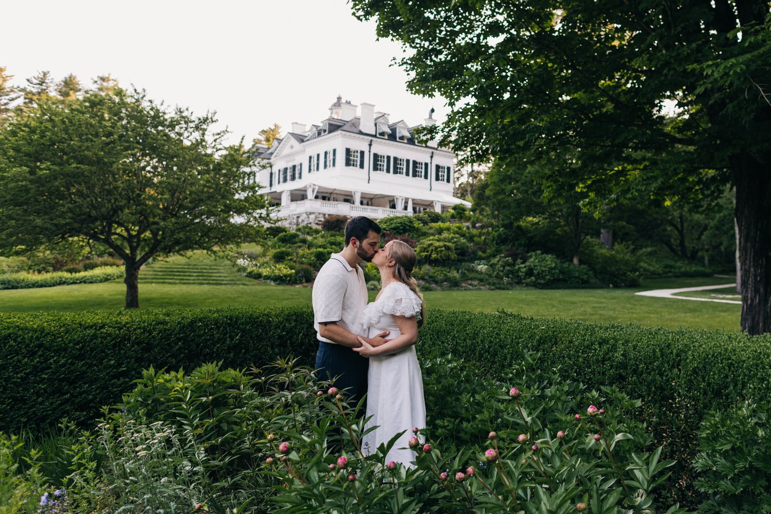 A couple enjoys a picnic while exploring the grounds at their engagement sessionat the Mount, Edith Wharton's Home, in Lenox, Massachusetts.