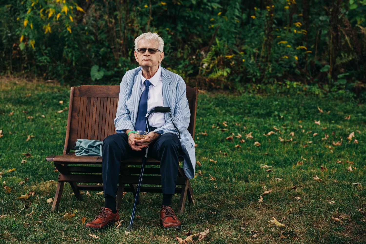 A man sits by himself during a wedding at western massachusetts wedding venue Gloriosa & Co in Ashfield, Massachusetts.