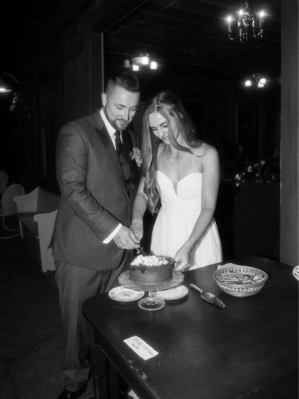 A bride and groom cut their wedding cake during a wedding at western massachusetts wedding venue Gloriosa & Co in Ashfield, Massachusetts.