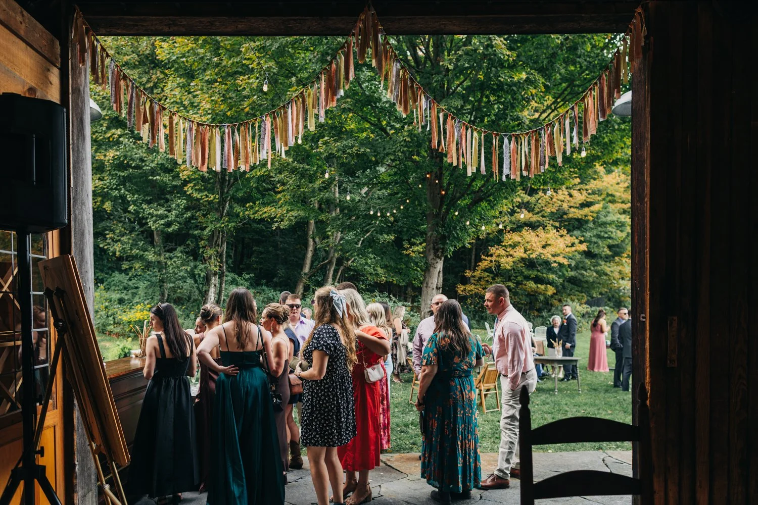 Guests enjoy social hour during a wedding at western massachusetts wedding venue Gloriosa & Co in Ashfield, Massachusetts.