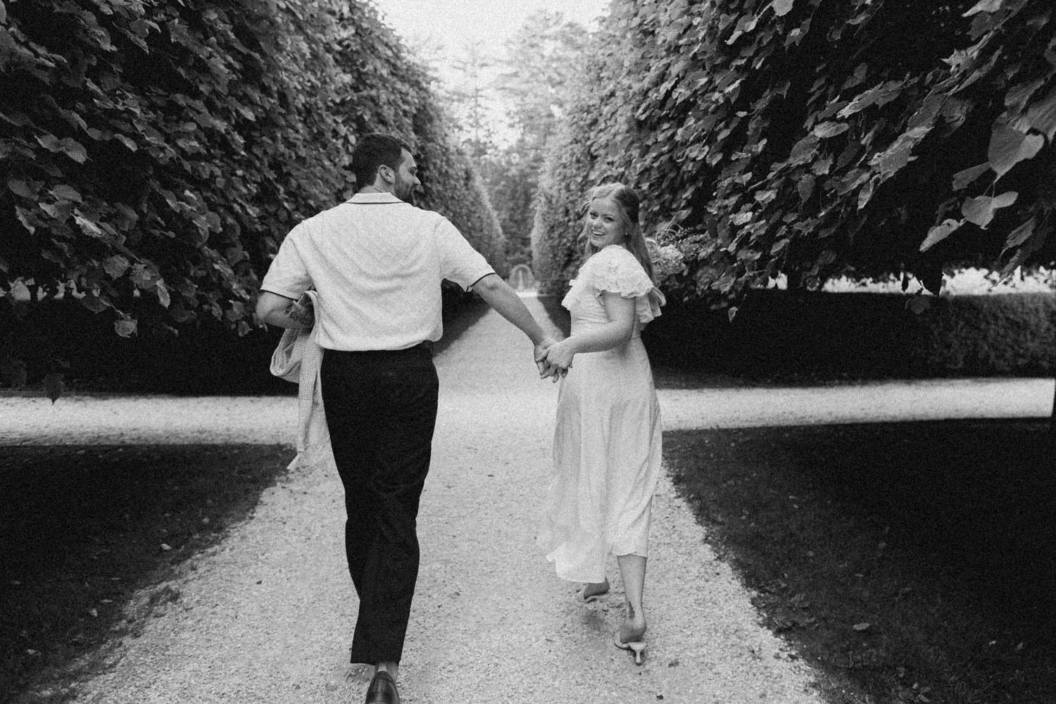A couple enjoys a picnic while exploring the grounds at their engagement sessionat the Mount, Edith Wharton's Home, in Lenox, Massachusetts.