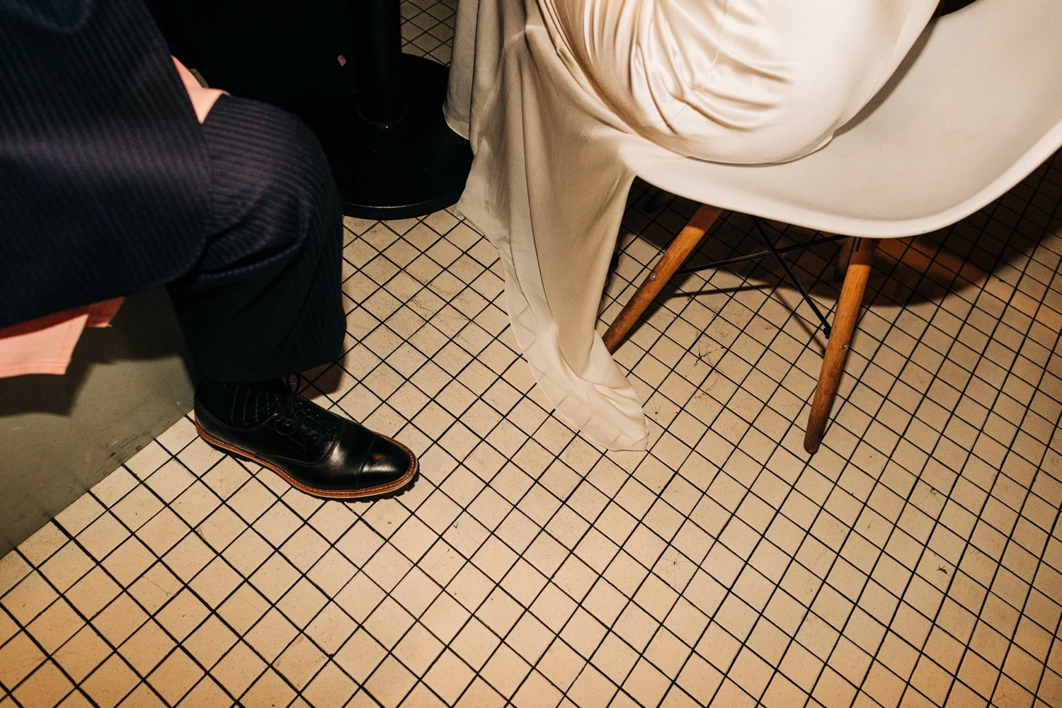 Detail photo of a bride's dress draping on the floor of the dining room at Juliet in Somerville, Massachusetts.