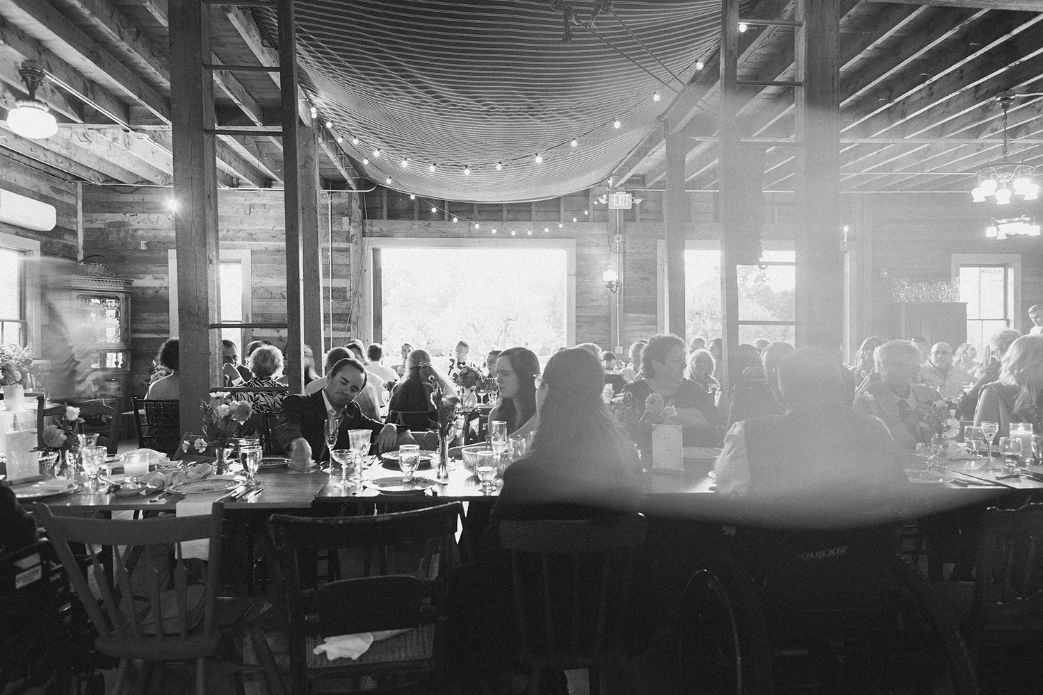 guests gather in the barn during a wedding at western massachusetts wedding venue gloriosa & co in ashfield, massachusetts