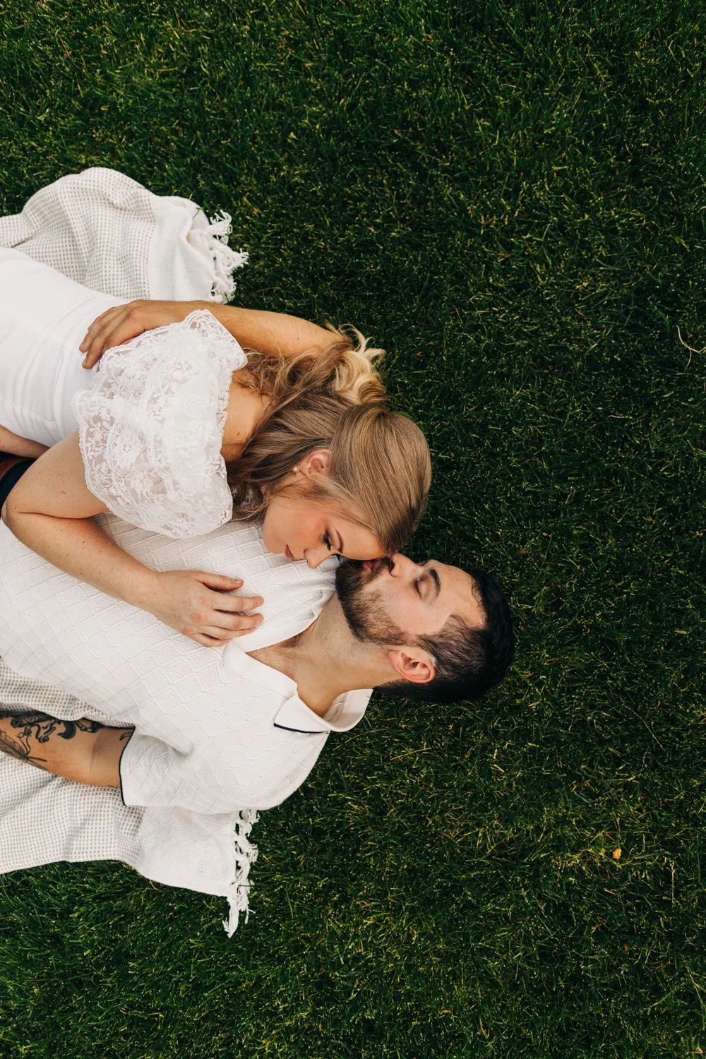 A couple enjoys a picnic while exploring the grounds at their engagement sessionat the Mount, Edith Wharton's Home, in Lenox, Massachusetts.