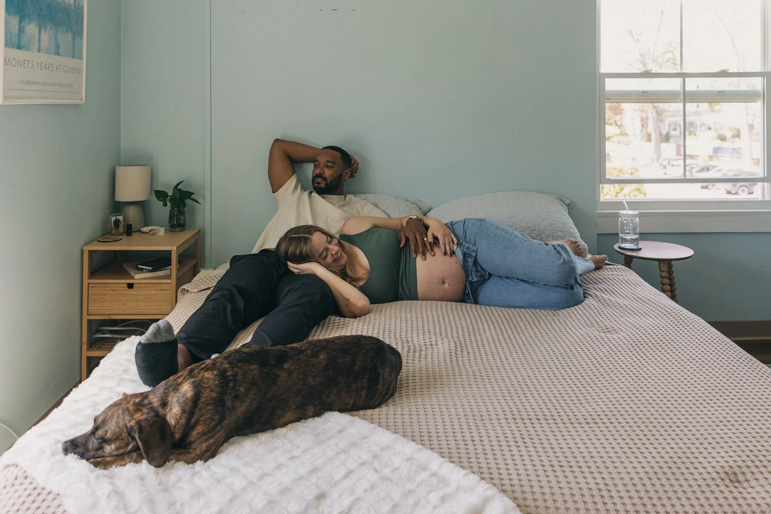A couple rests together during their maternity photo session in massachusetts.