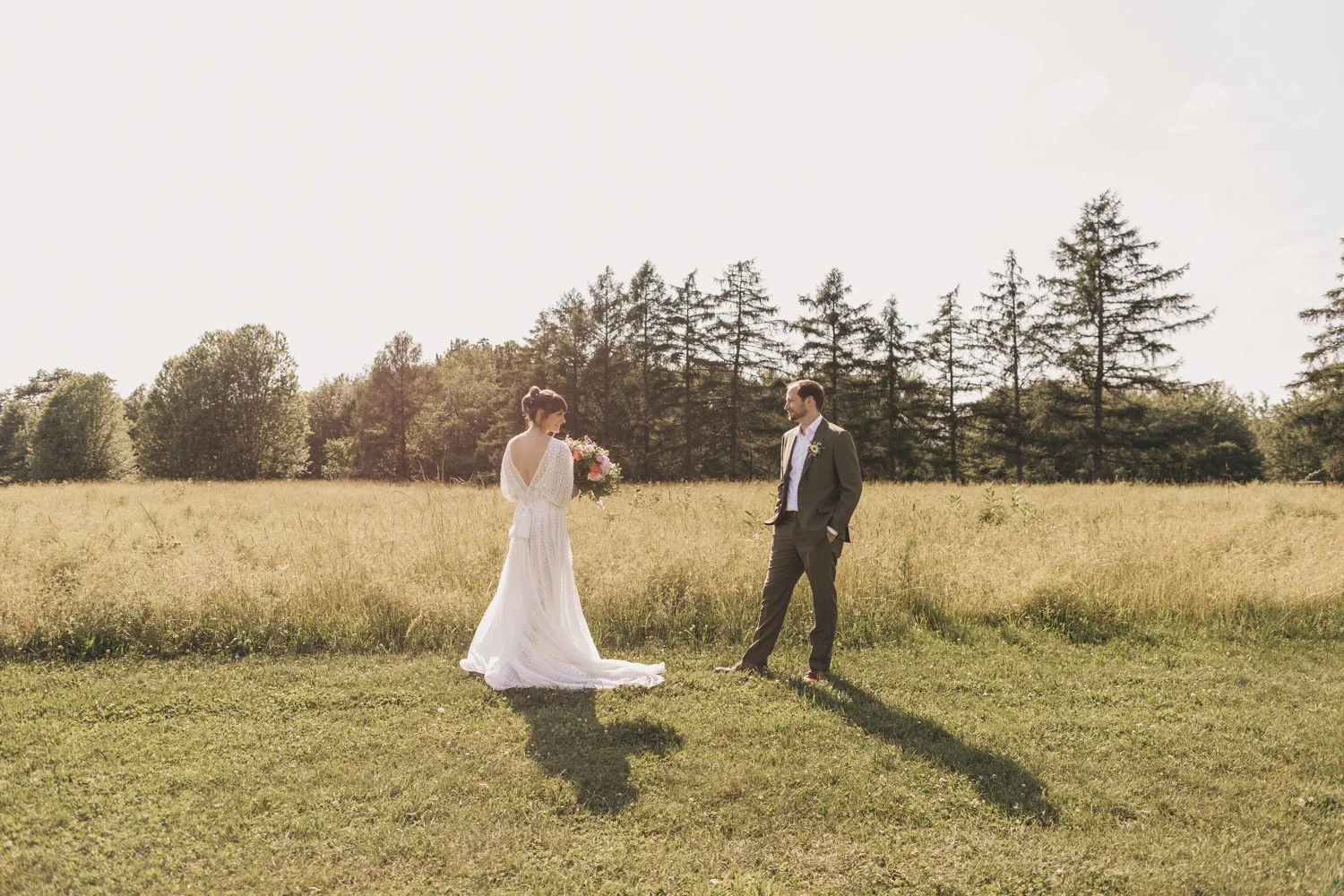 Portrait of a bride and groom in the meadow at the Red Barn at Hampshire College in Amherst, Massachusetts.