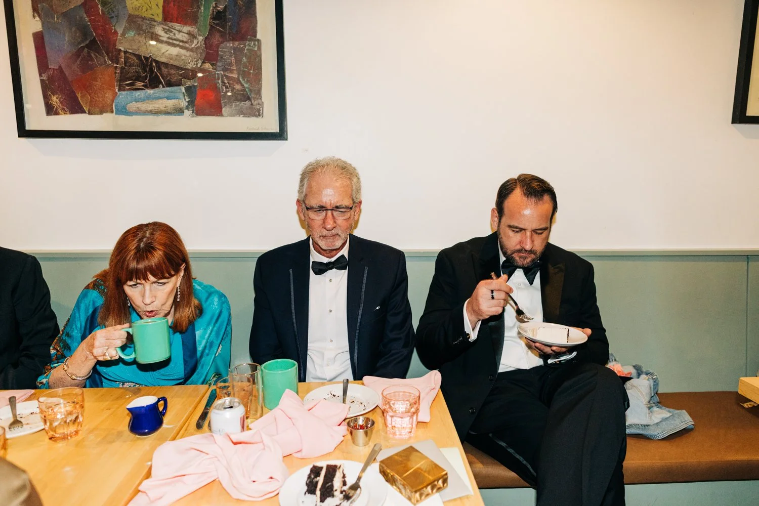 A groom enjoys cake and coffee with his family during his wedding reception at Juliet in Somerville, Massachusetts.