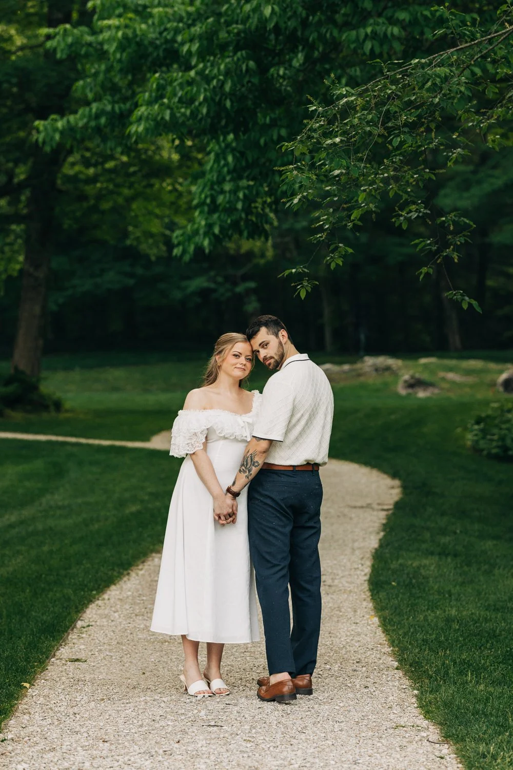 A couple enjoys a picnic while exploring the grounds at their engagement sessionat the Mount, Edith Wharton's Home, in Lenox, Massachusetts.