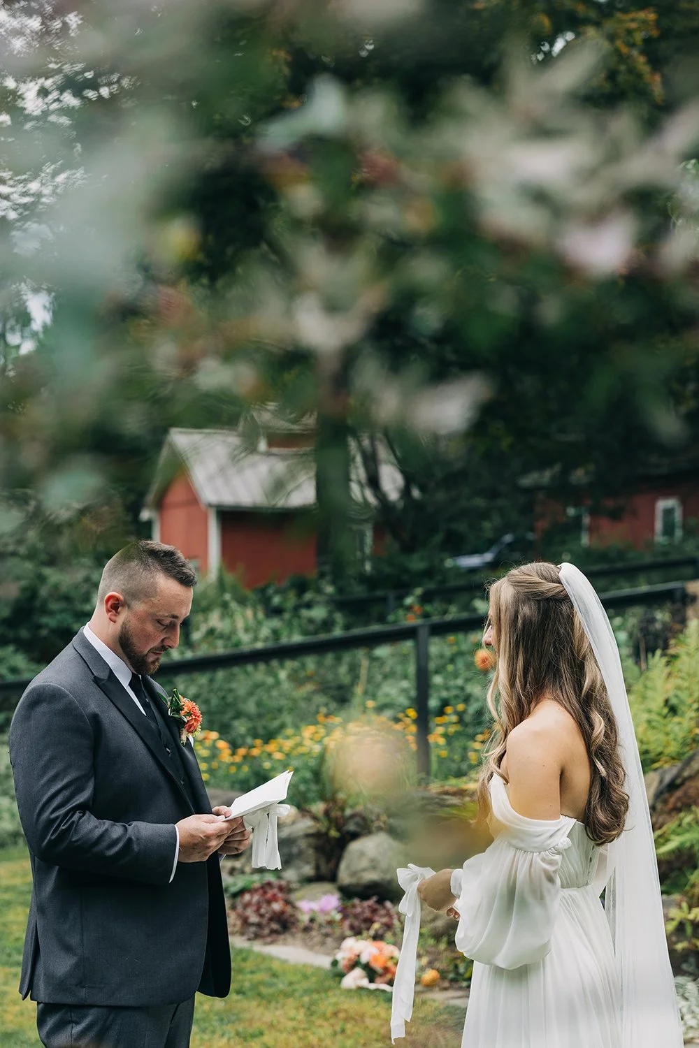 A bride and groom stand together in front of their family and friends during their wedding at western massachusetts wedding venue gloriosa and co