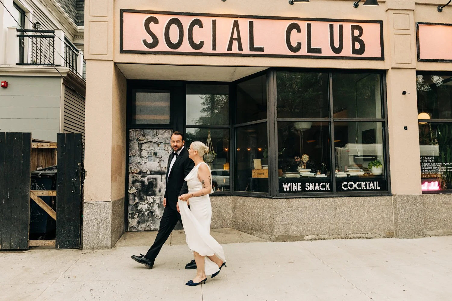 A couple walks down the street to their wedding celebration at Juliet in Somerville, Massachusetts.