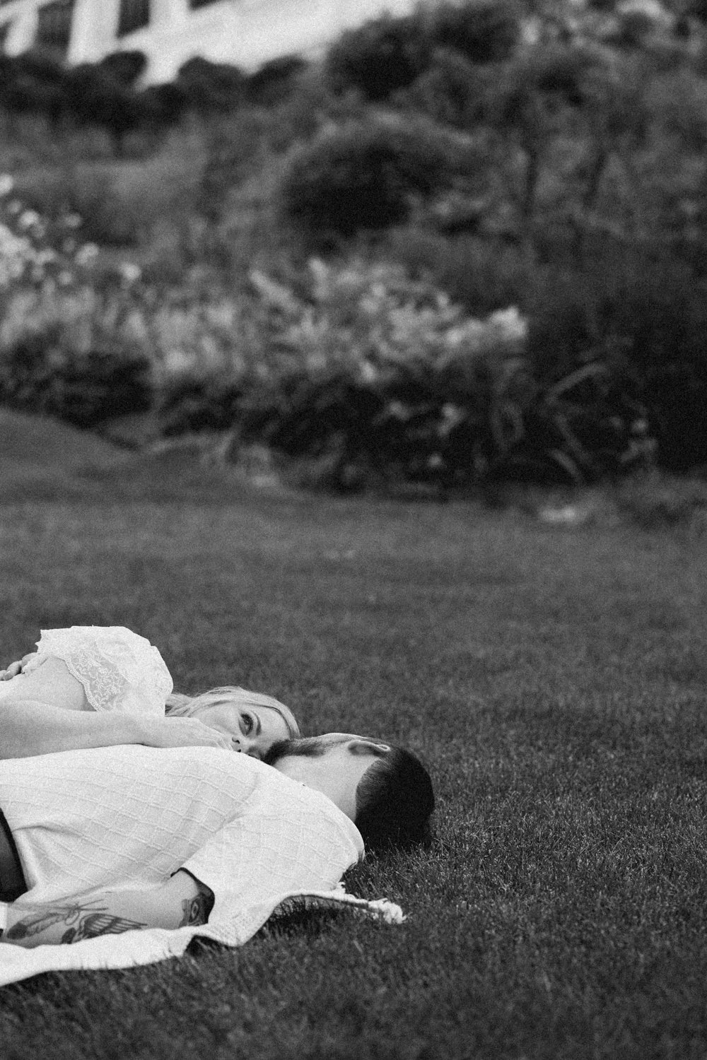 A couple enjoys a picnic while exploring the grounds at their engagement sessionat the Mount, Edith Wharton's Home, in Lenox, Massachusetts.