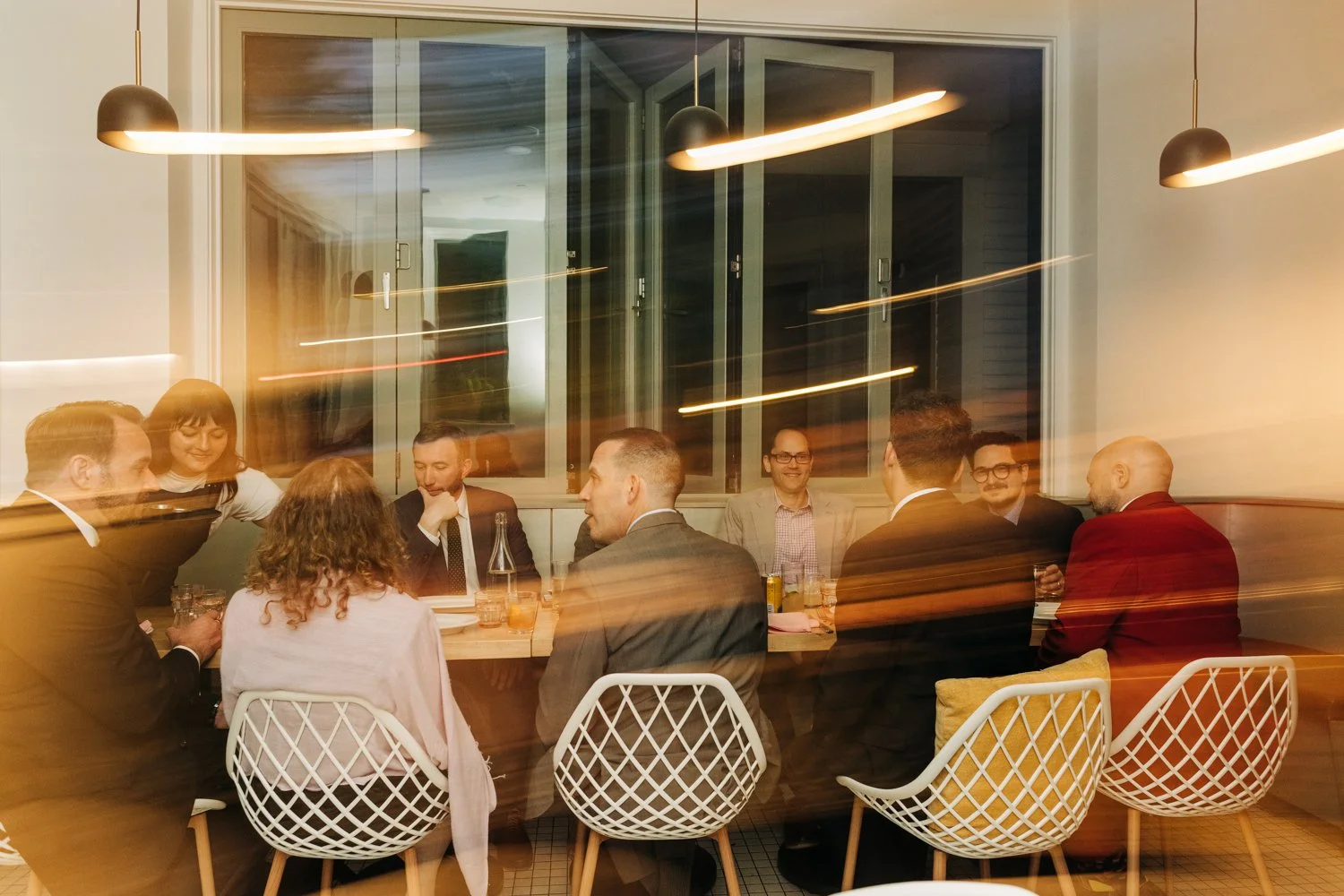 Friends gather for food and drinks during a wedding celebration at Juliet in Somerville, Massachusetts.