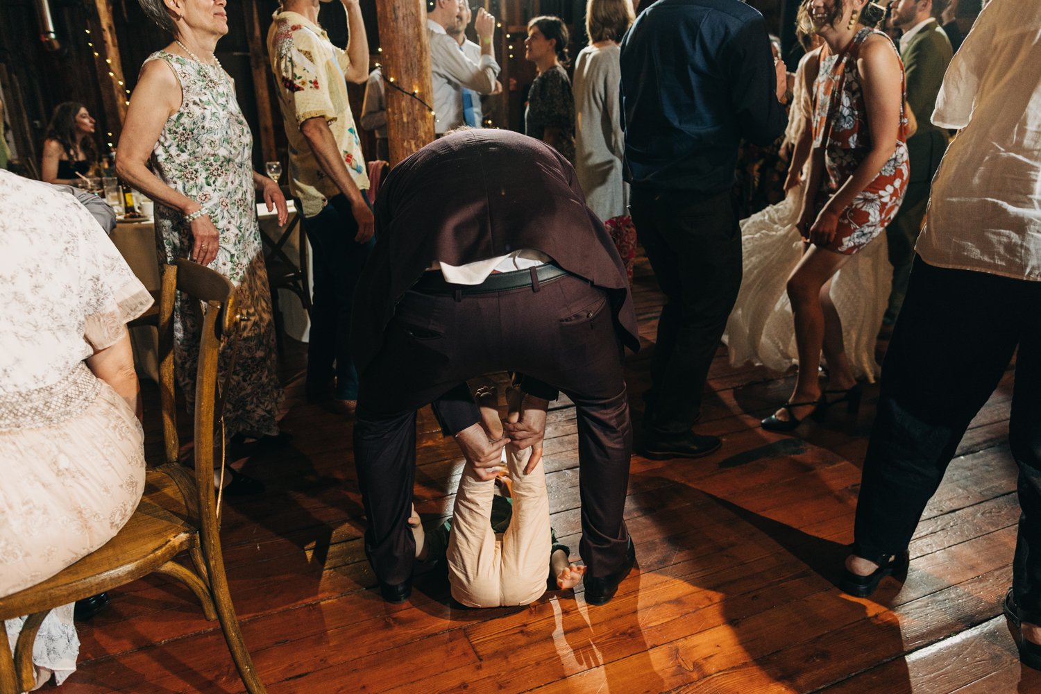 Weddin guests dance during a wedding reception at the red barn at hampshire college in amherst, massachusetts