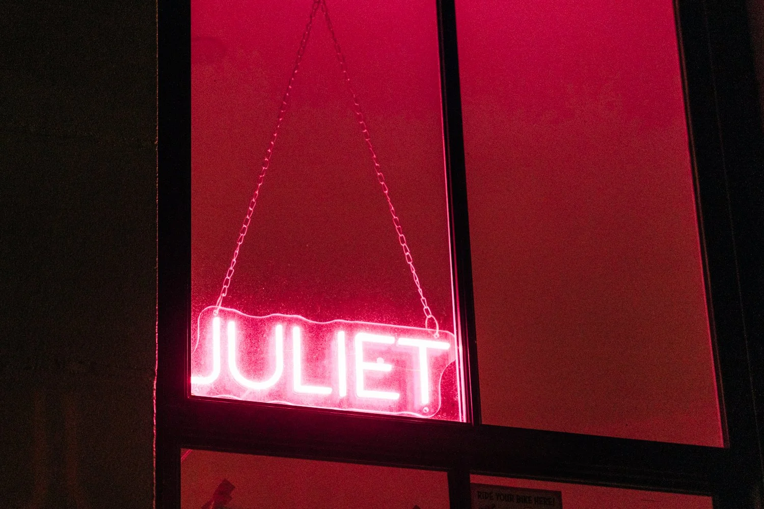 A neon sign is turned on outside of Juliet in Somerville, Massachusetts.