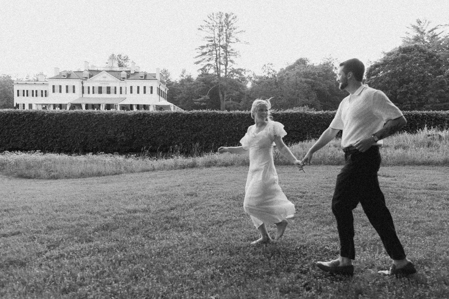 A couple enjoys a picnic while exploring the grounds at their engagement sessionat the Mount, Edith Wharton's Home, in Lenox, Massachusetts.