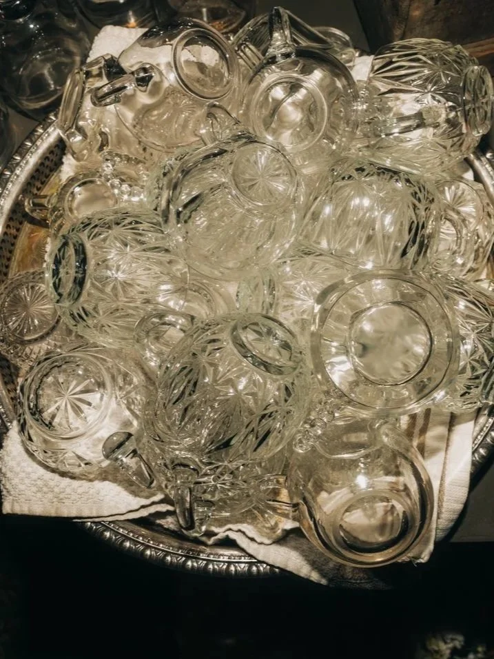Vintage cups are piled up on a tray during a wedding at western massachusetts wedding venue Gloriosa & Co in Ashfield, Massachusetts.