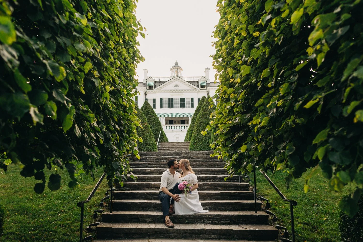 A couple enjoys a picnic while exploring the grounds at their engagement sessionat the Mount, Edith Wharton's Home, in Lenox, Massachusetts.