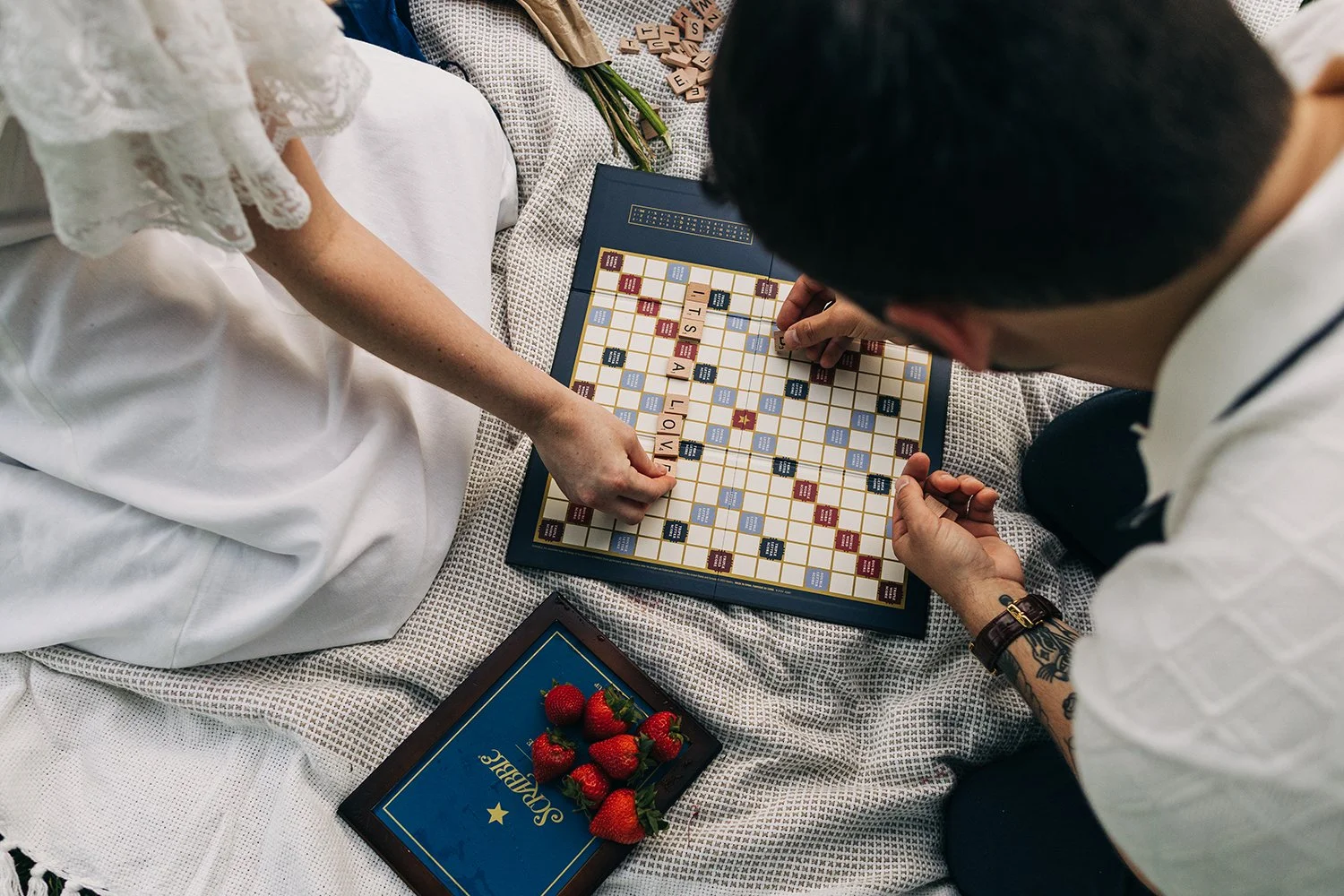 A couple enjoys a picnic while exploring the grounds at their engagement sessionat the Mount, Edith Wharton's Home, in Lenox, Massachusetts.