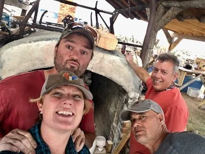 Four potters in front of an Anagama style wood fire kiln in New Mexico.