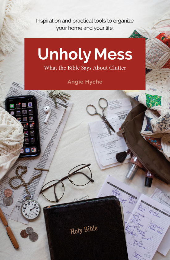 Cluttered tabletop with a Holy Bible, glasses, paper receipts, coins, a phone, a watch, jewelry, a notebook, handwritten notes, a pair of scissors, and various laundry items, including a quilt.