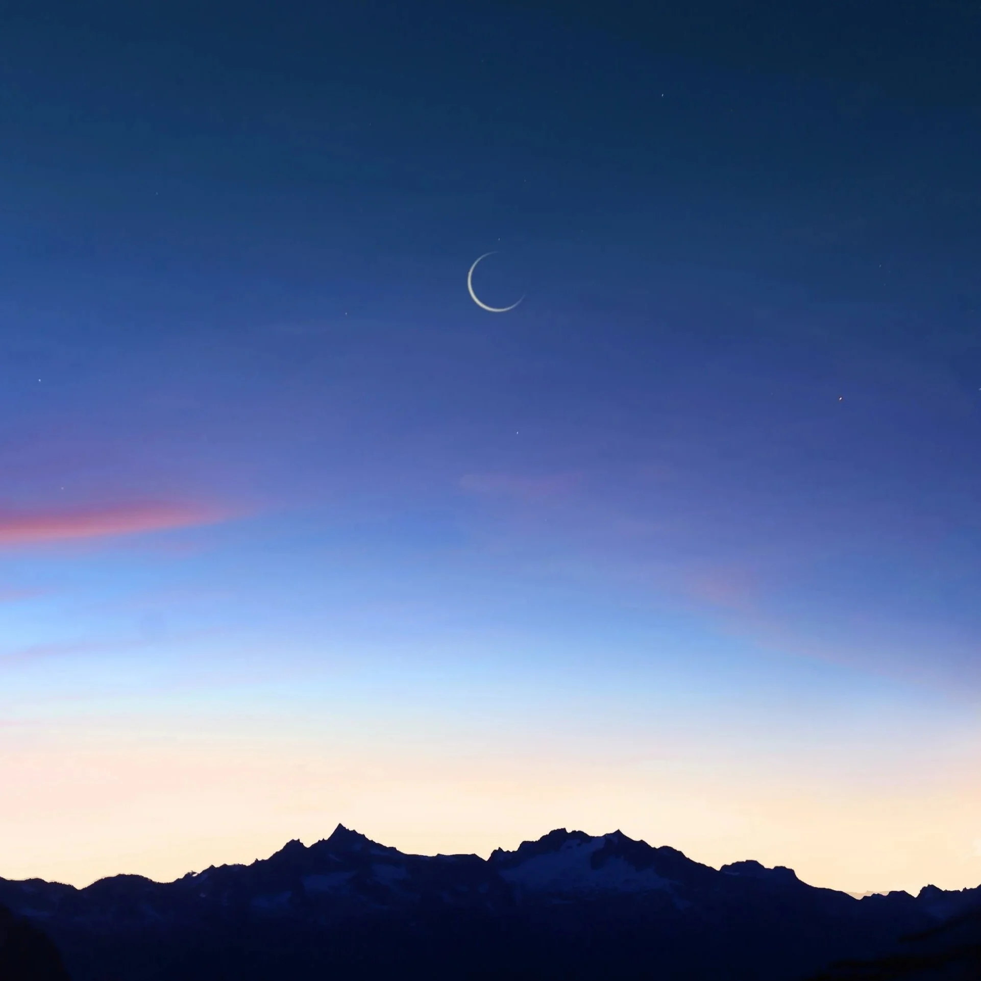 A crescent moon over mountains to symbolize healing and growth.