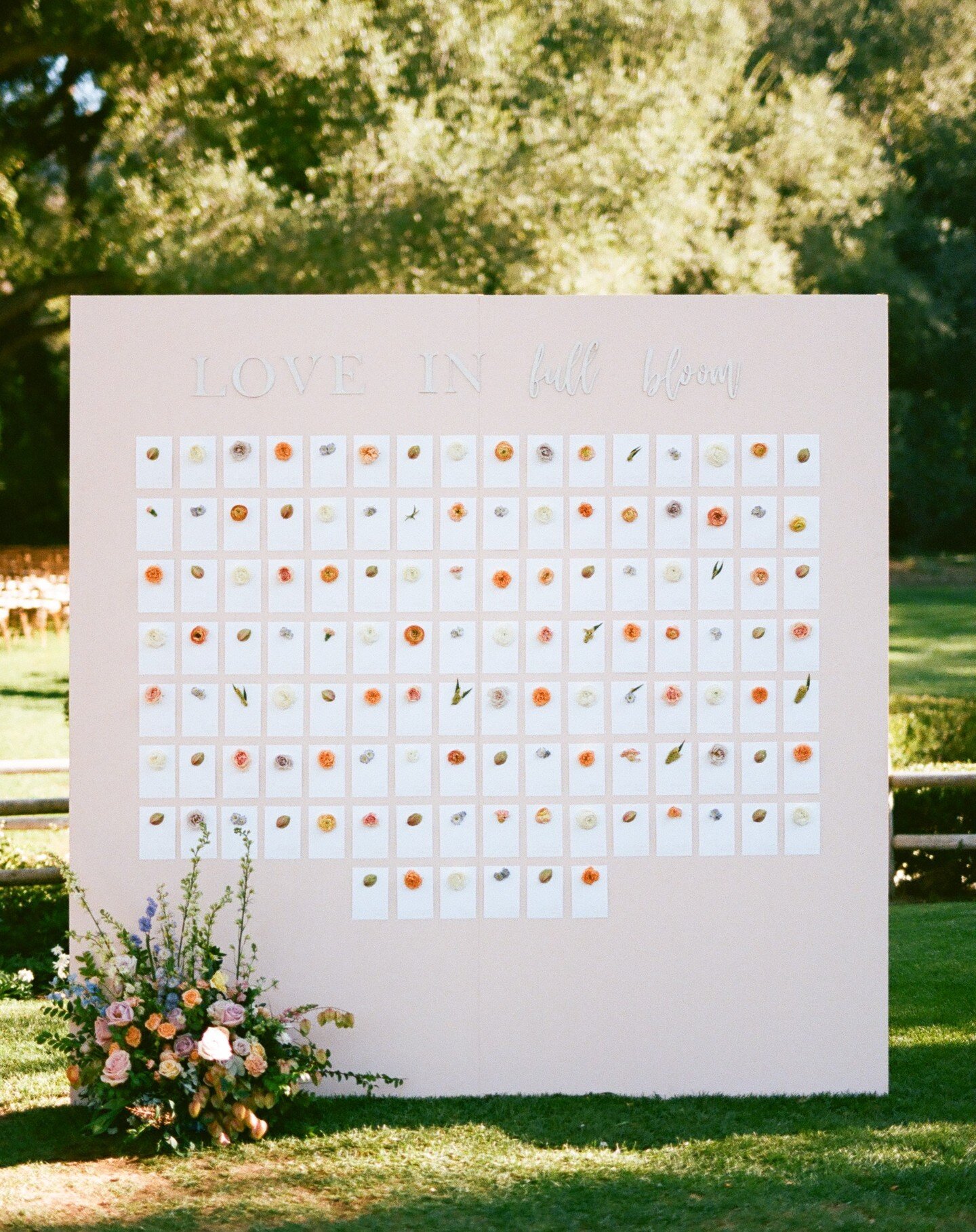 A stunning wedding captured on film 💖 It was an honor to have a small part in such a perfect day designing the escort cards for this fun seating chart! Each card had a floral attached to it, adding just the right amount of color. Love was definitely