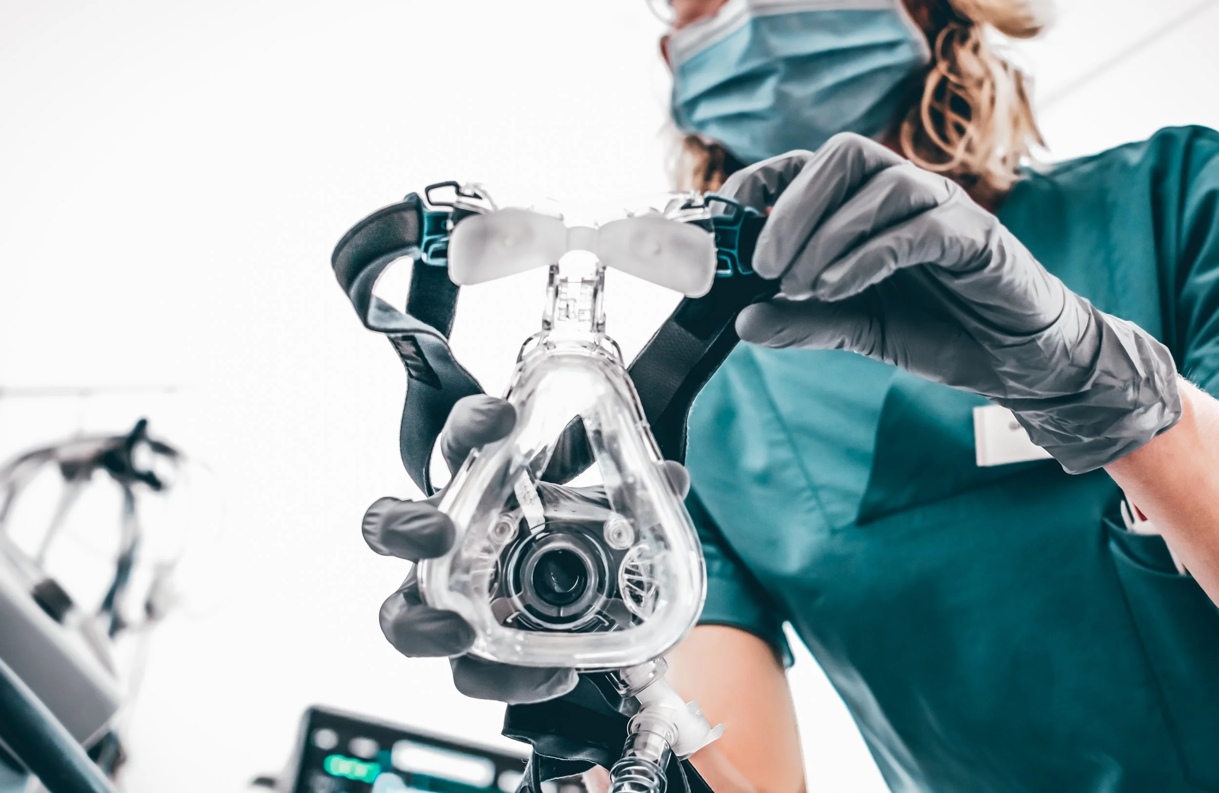 Medical professional attends to a patient during specialized sleep apnea treatment in a clinical setting.