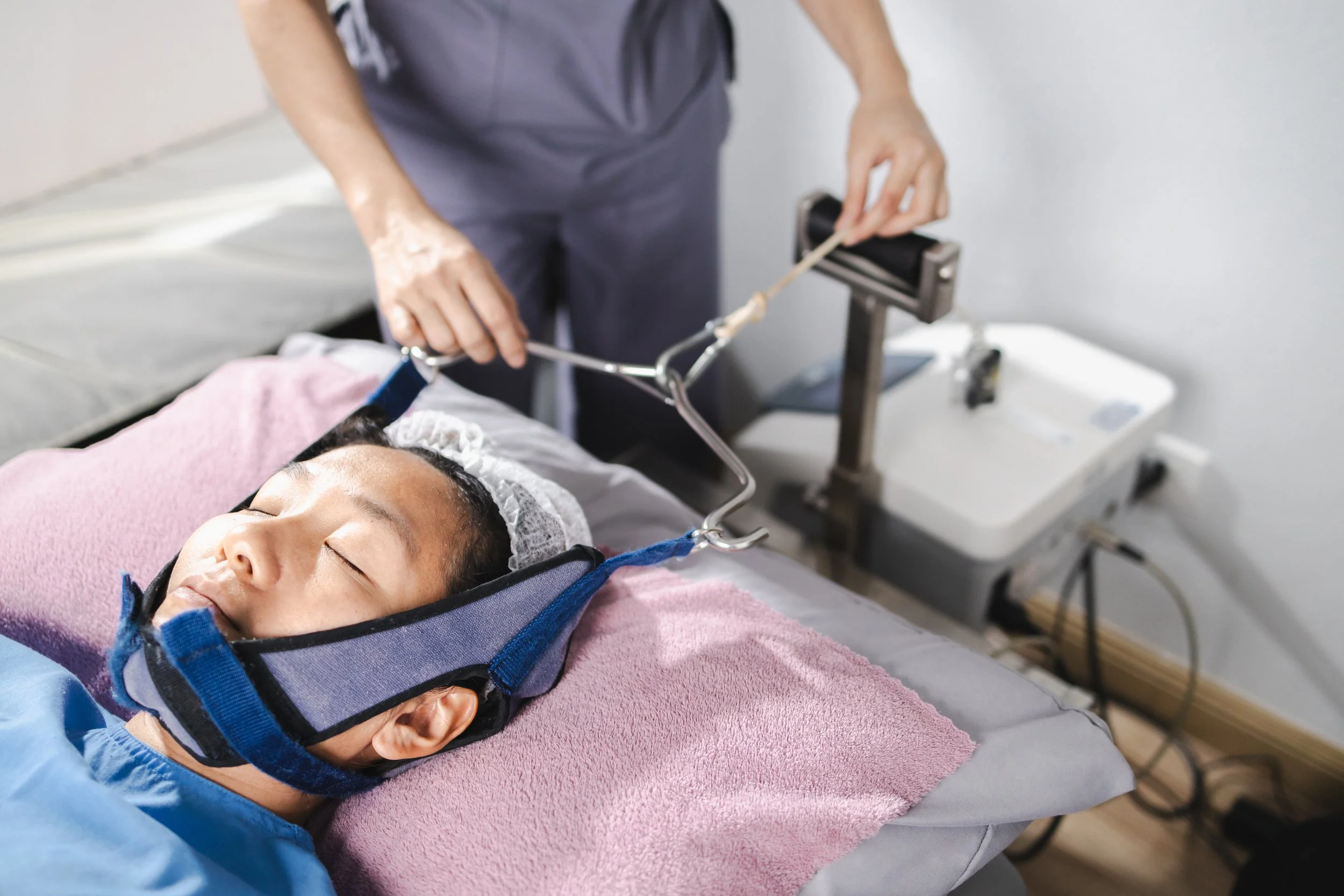 Patient receives monitored sleep apnea treatment while resting with medical equipment in a clinical setting in Boulder.