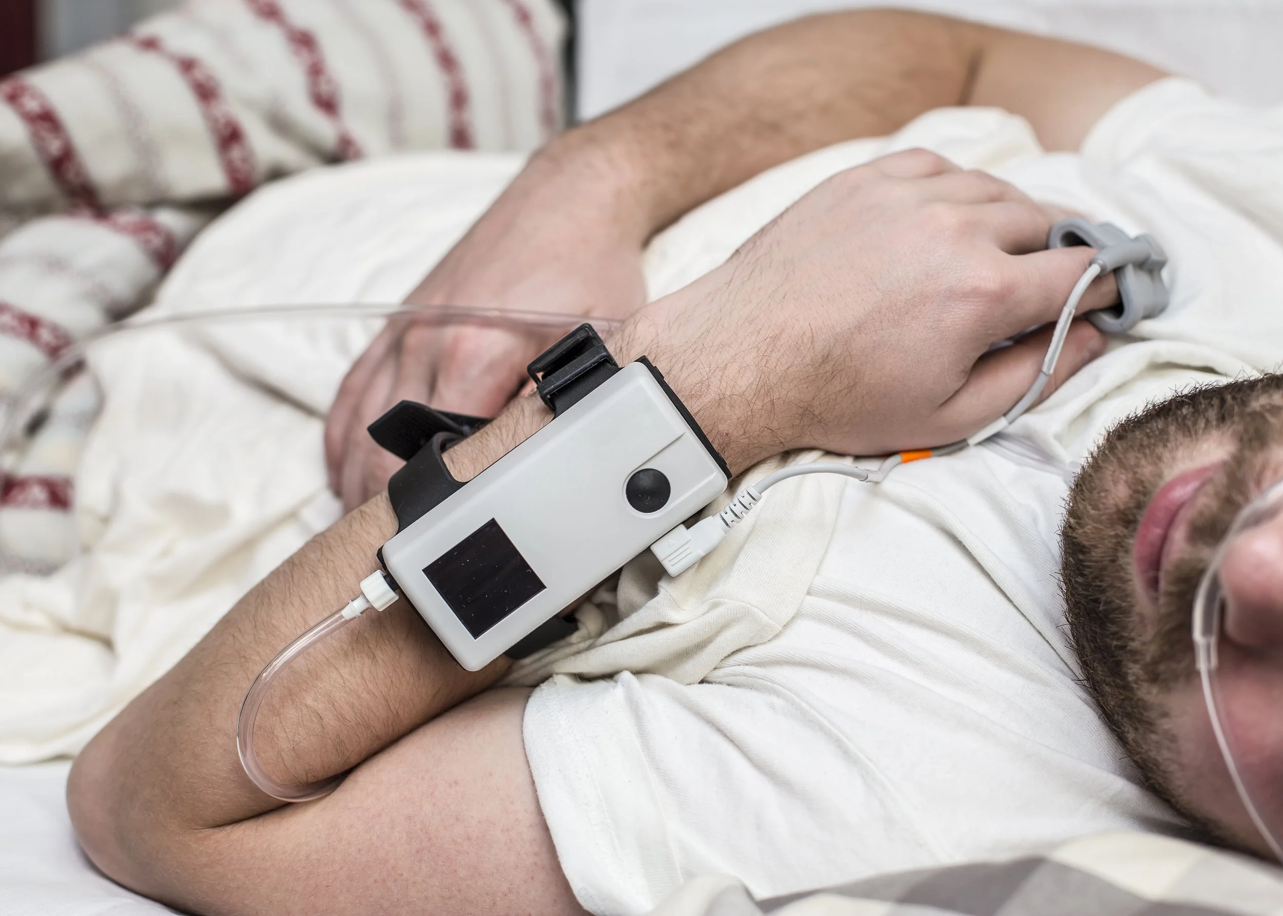 Close-up of a patient wearing sleep monitoring equipment during an overnight breathing assessment.

