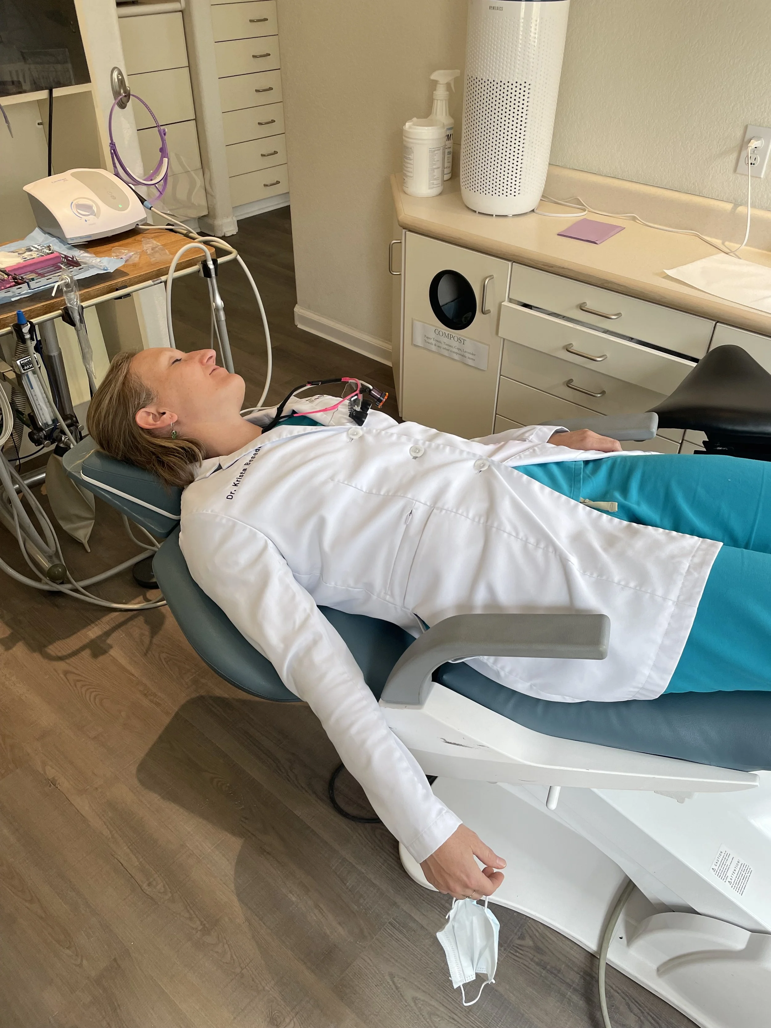 Woman reclines in a clinic while connected to medical equipment during a monitored sleep evaluation.