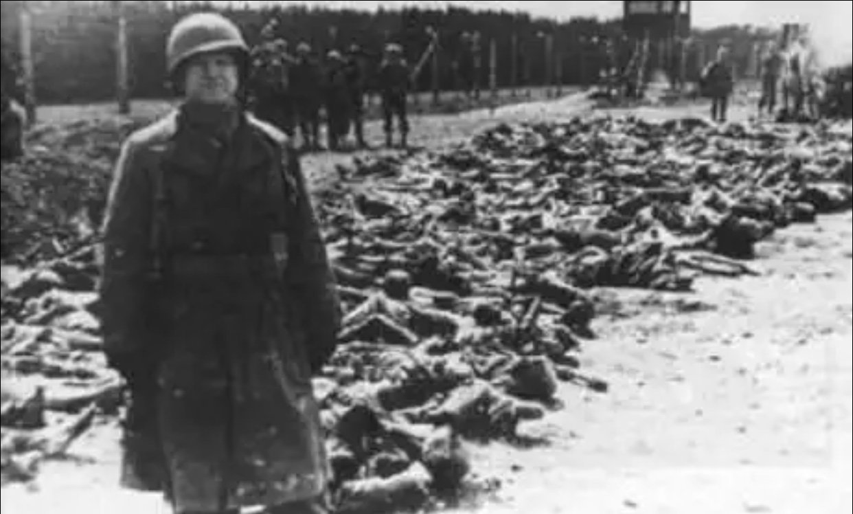  French soldier stands in front of some of the victims of the Sétif Massacre, 1945 //  Middle East Monitor   