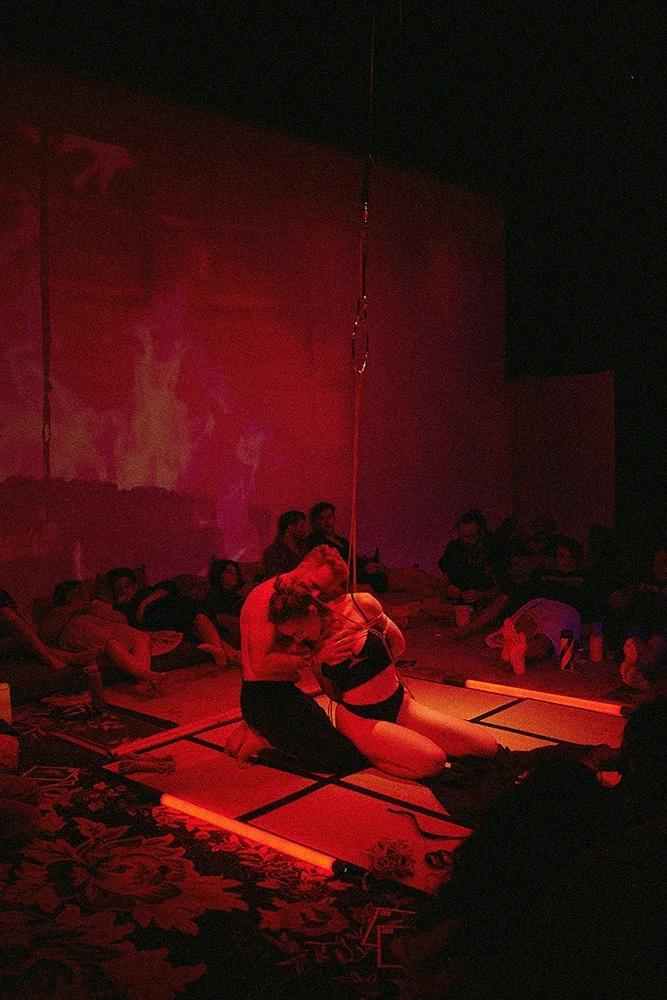 Contemporary Shibari performance by Dan Carabas and Dorcara featuring rope aesthetics, sculptural tension, in a Shibari suspension.