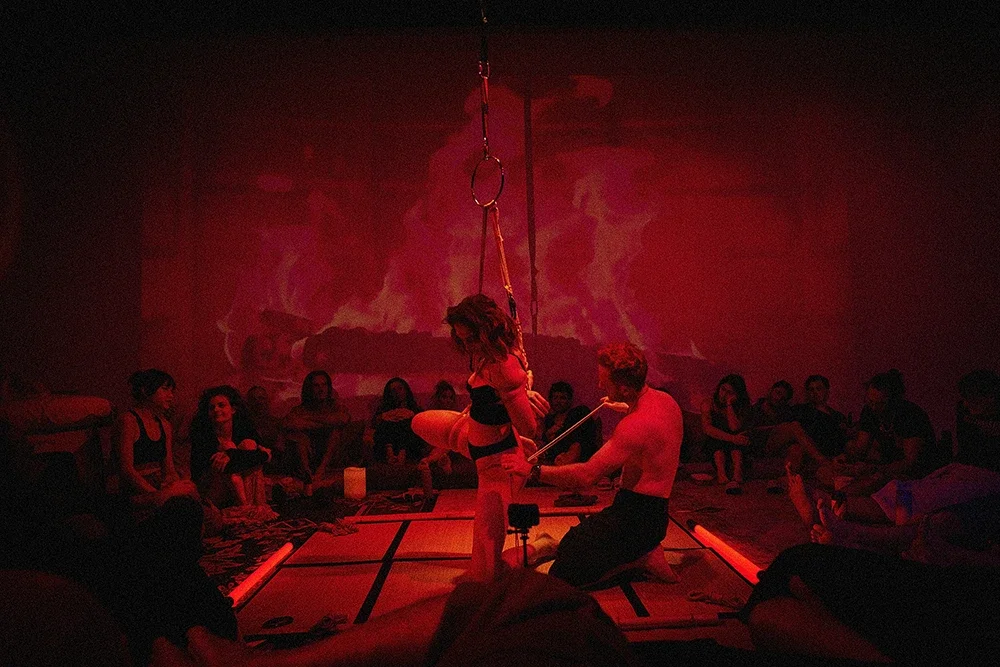 Contemporary Shibari performance by Dan Carabas and Dorcara featuring rope aesthetics, sculptural tension, in a Shibari suspension.