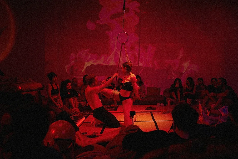 Contemporary Shibari performance by Dan Carabas and Dorcara featuring rope aesthetics, sculptural tension, in a Shibari suspension.