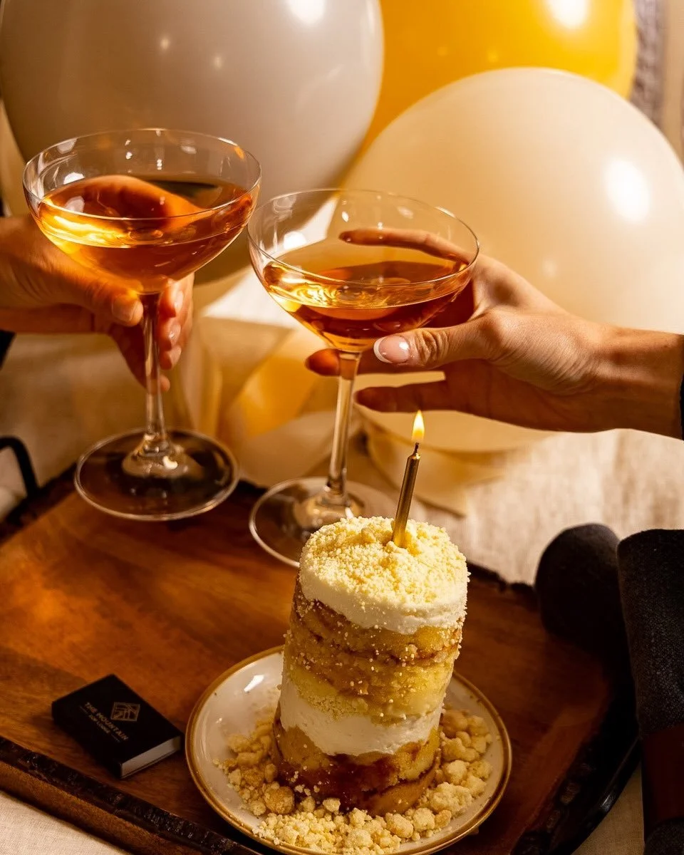 Golden hour, a quiet room, two glasses raised to something worth remembering.

The Celebration Experience is our way of marking the moments that matter &mdash; a chilled bottle of Veuve Clicquot, a petite cake made to be wished upon, and just enough 