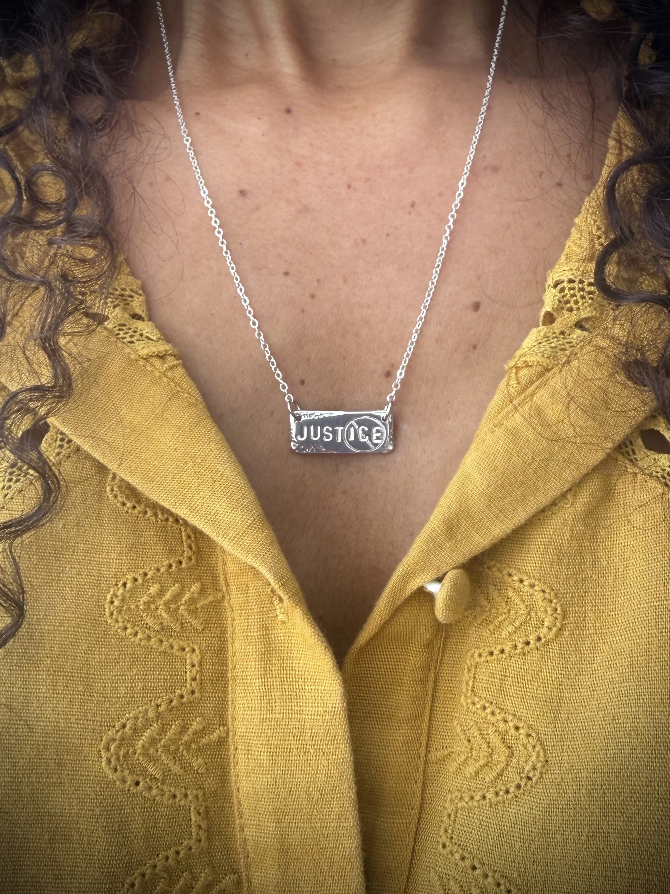 Justice necklace silver on neck.jpg