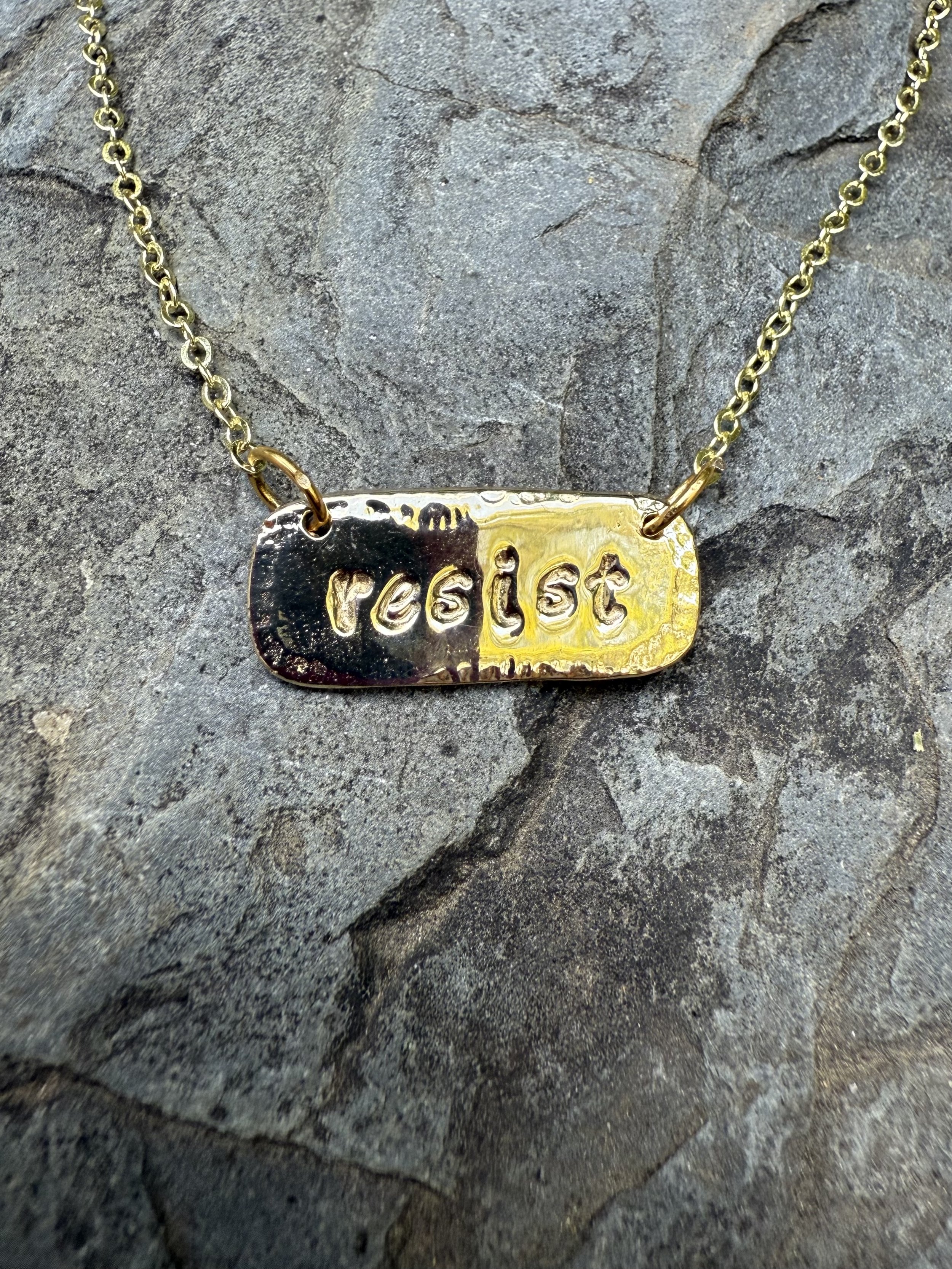 resist lowercase brass.jpg