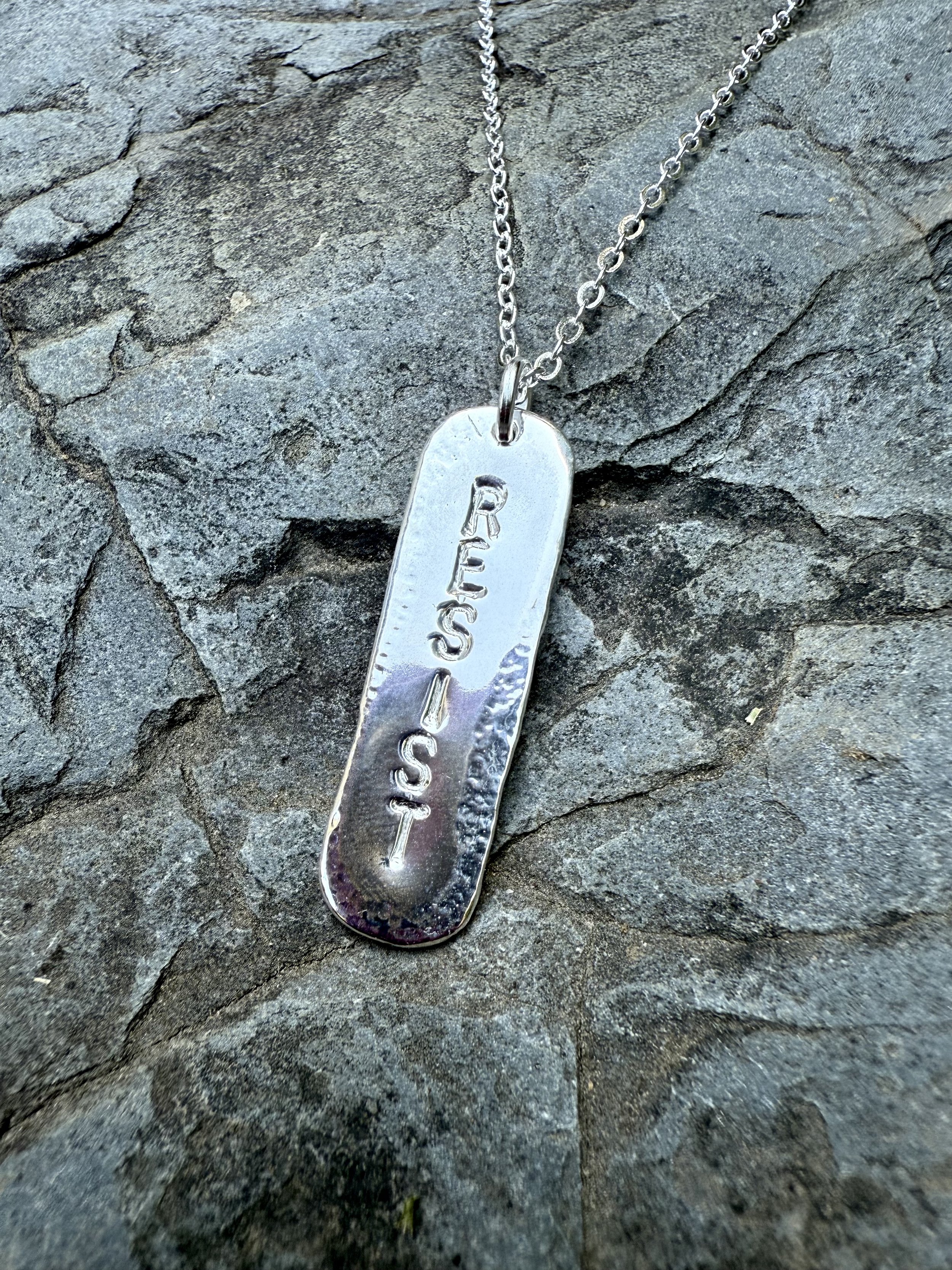 RESIST uppercase silver.jpg