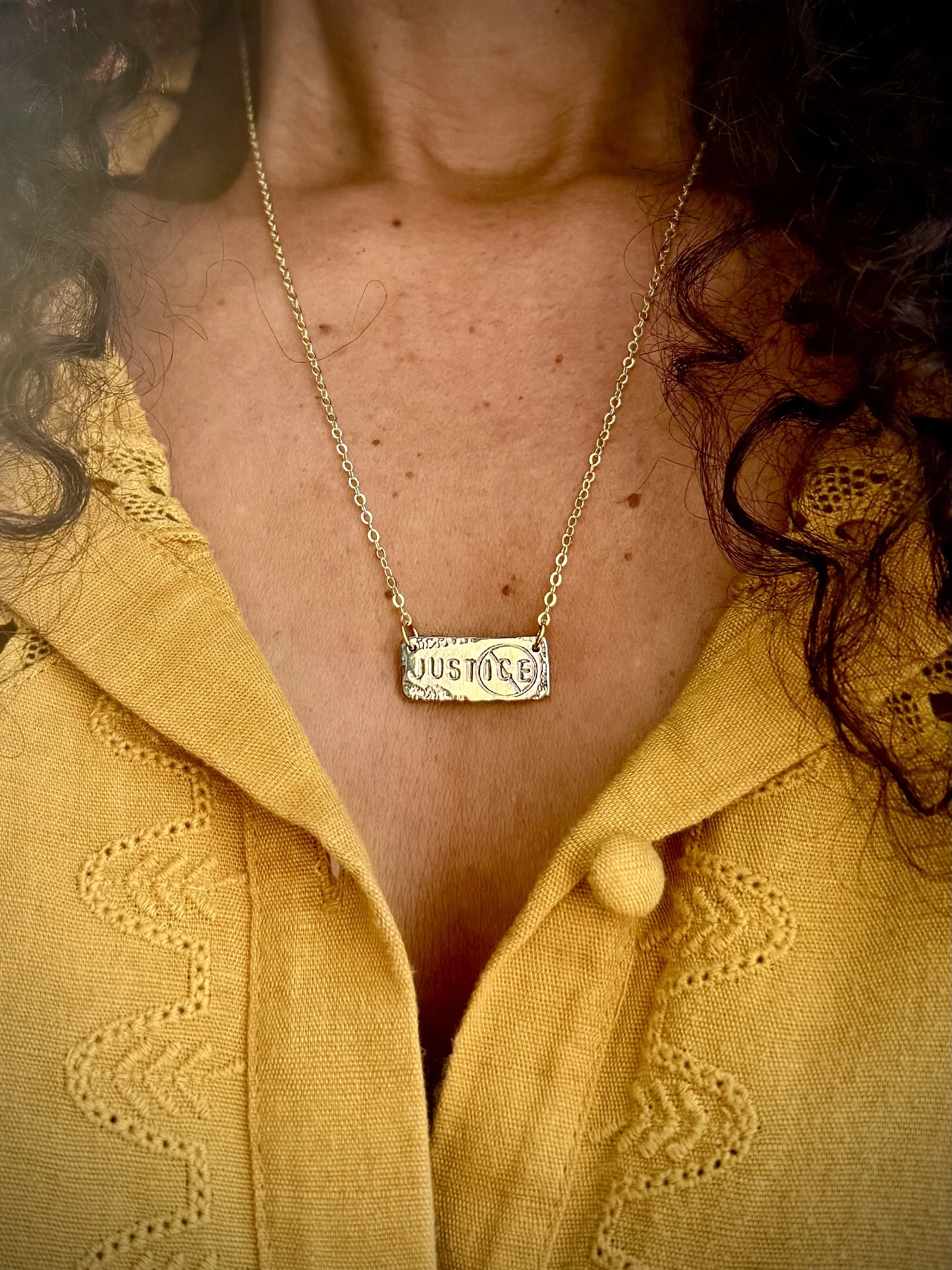 Justice necklace brass on neck.jpg