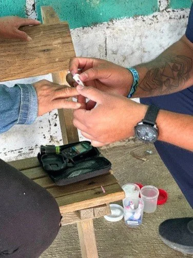 Close up of hands testing blood for diabetes